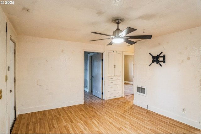 spare room featuring ceiling fan, visible vents, baseboards, and light wood-style flooring