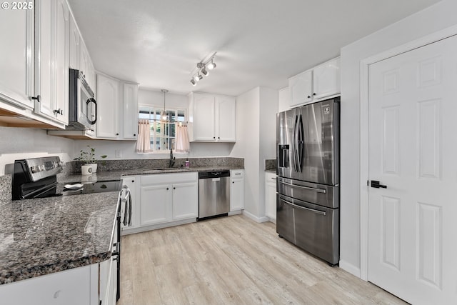 222 NE Darcie Way, Myrtle Creek, OR 97457 - kitchen featuring appliances with stainless steel finishes, a sink, white cabinets, and light wood-style floors