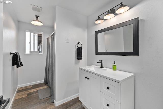 222 NE Darcie Way, Myrtle Creek, OR 97457 - full bathroom with vanity, wood finished floors, and baseboards