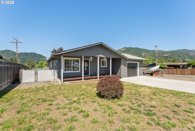 222 NE Darcie Way, Myrtle Creek, OR 97457 - single story home featuring a garage, covered porch, concrete driveway, and a mountain view