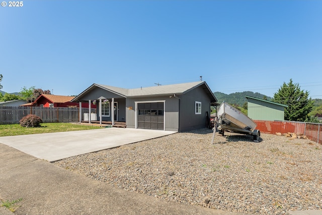 222 NE Darcie Way, Myrtle Creek, OR 97457 - back of property with an attached garage, concrete driveway, and a porch