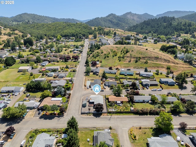 222 NE Darcie Way, Myrtle Creek, OR 97457 - aerial view of property and surrounding area featuring a mountainous background and nearby suburban area
