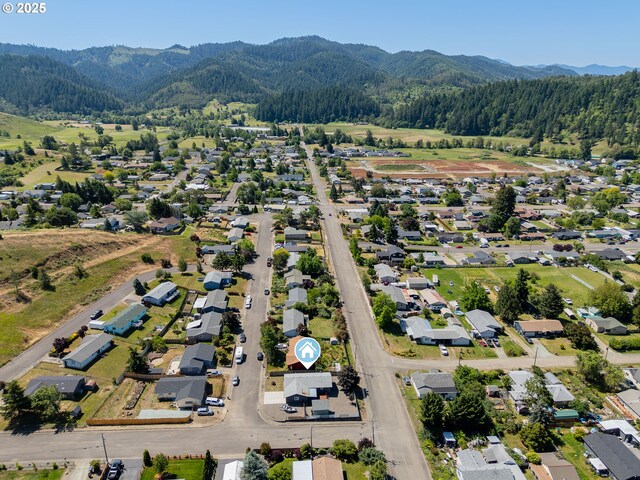 222 NE Darcie Way, Myrtle Creek, OR 97457 - aerial overview of property's location with mountains, a forest, and nearby suburban area