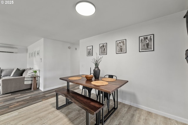 222 NE Darcie Way, Myrtle Creek, OR 97457 - dining room with wood finished floors, a wall mounted air conditioner, and baseboards