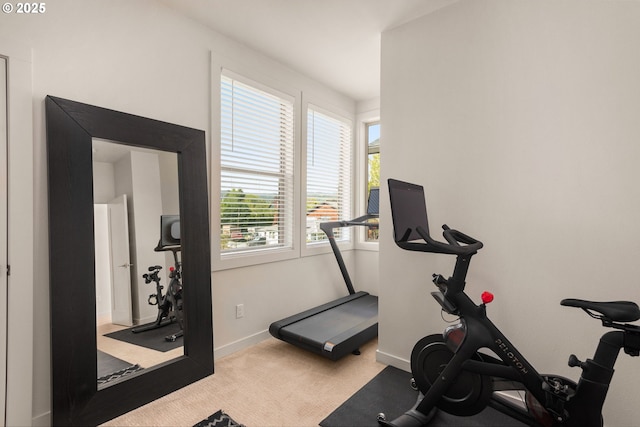 workout area featuring carpet flooring and baseboards