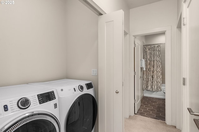 washroom featuring laundry area, washer and dryer, and light colored carpet