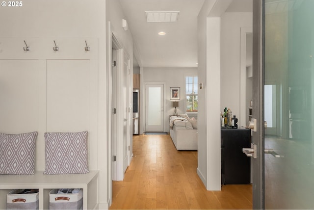 corridor with recessed lighting, light wood-style flooring, and visible vents