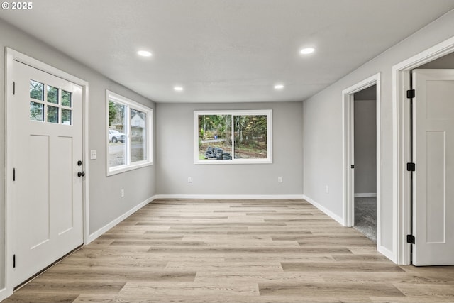 entrance foyer with light hardwood / wood-style floors and plenty of natural light