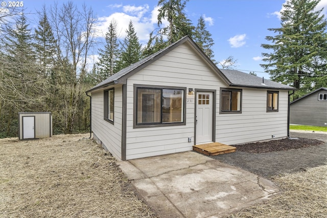 view of front of house featuring a storage shed and a patio area