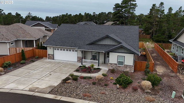 craftsman house featuring covered porch, stone siding, a shingled roof, and an attached garage