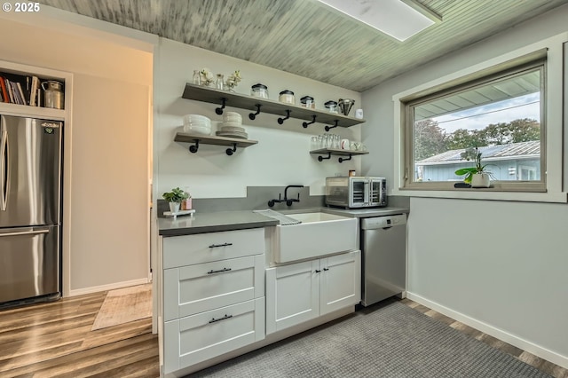 8413 NE Lewis Dr, Vancouver, WA 98662 - kitchen featuring appliances with stainless steel finishes, open shelves, a sink, wood finished floors, and dark countertops