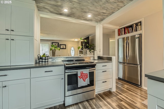 8413 NE Lewis Dr, Vancouver, WA 98662 - kitchen with appliances with stainless steel finishes, dark wood-style flooring, dark countertops, and white cabinetry