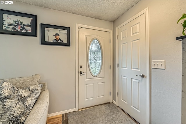 8413 NE Lewis Dr, Vancouver, WA 98662 - foyer with a textured ceiling, baseboards, and wood finished floors