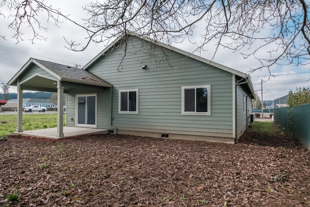 back of house featuring a patio area and fence