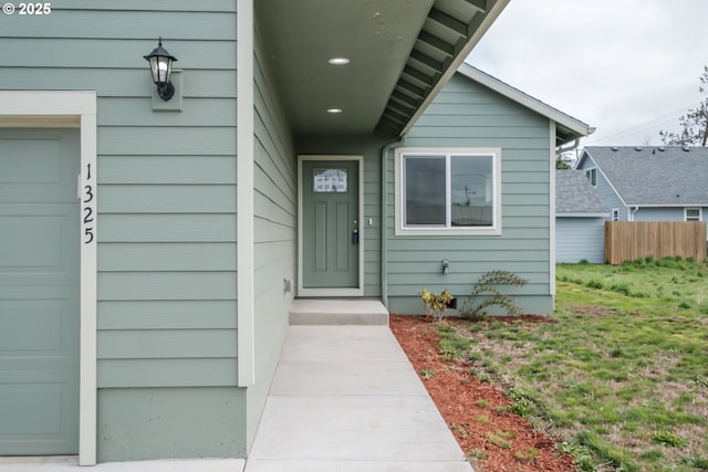 entrance to property with a garage and fence