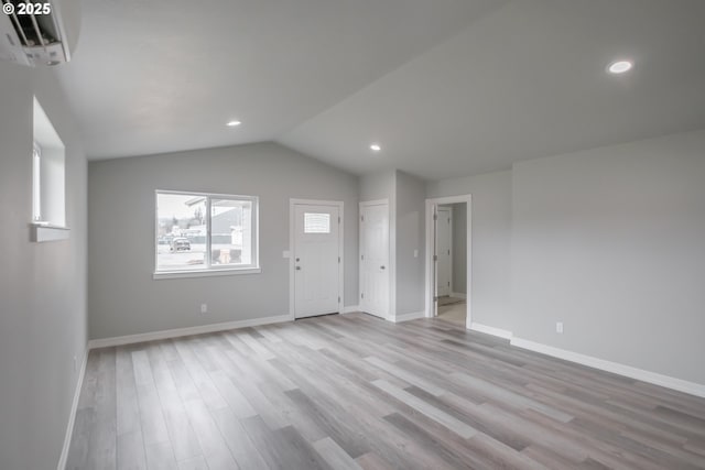 interior space featuring vaulted ceiling, light wood finished floors, recessed lighting, and baseboards