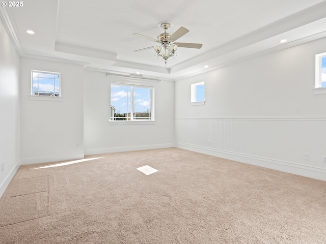 carpeted empty room with a wainscoted wall, a tray ceiling, a ceiling fan, and recessed lighting