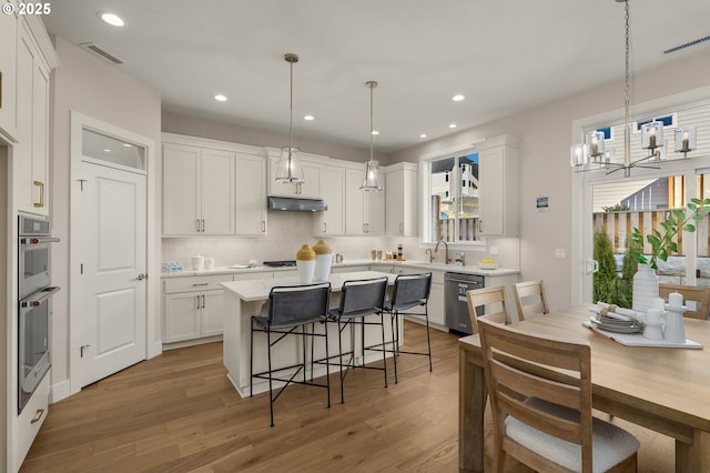 4420 NW 178th Ter Lot 27, Portland, OR 97229 - kitchen featuring stainless steel appliances, a sink, white cabinetry, tasteful backsplash, and recessed lighting