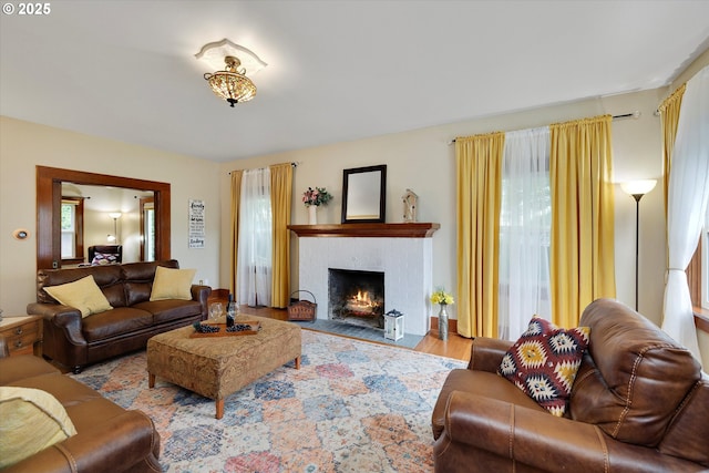636 S Nehalem St, Clatskanie, OR 97016 - living area featuring wood finished floors, a fireplace with flush hearth, and healthy amount of natural light