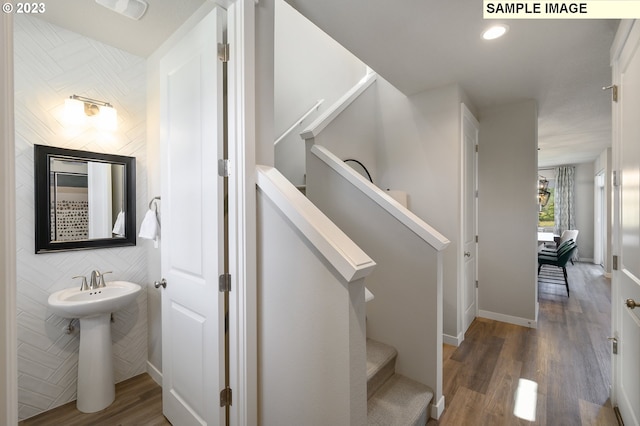 stairs featuring hardwood / wood-style floors