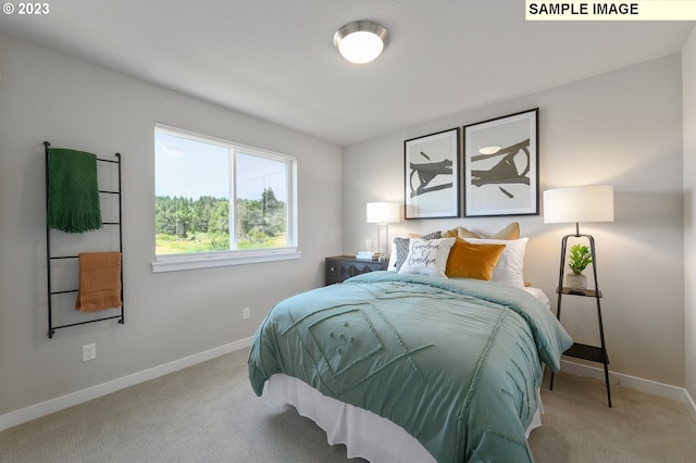 bedroom featuring light carpet