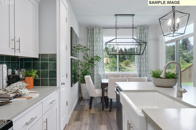 interior space with sink, a chandelier, and light wood-type flooring