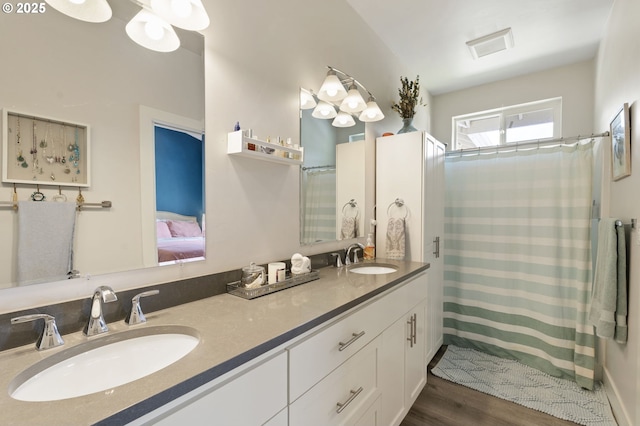 367 E 4th St, Lowell, OR 97452 - ensuite bathroom featuring double vanity, wood finished floors, and a shower with curtain