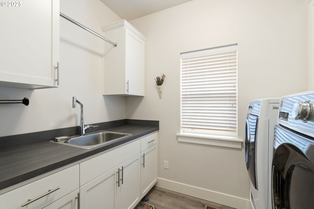 367 E 4th St, Lowell, OR 97452 - washroom featuring cabinet space, wood finished floors, baseboards, and washing machine and dryer