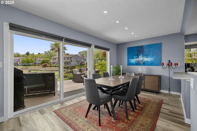 620 N Hayden Bay Dr, Portland, OR 97217 - dining room with a textured ceiling, recessed lighting, baseboards, and light wood-style flooring