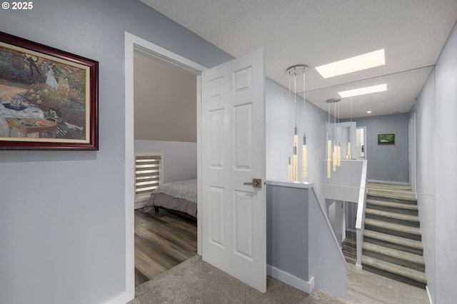 620 N Hayden Bay Dr, Portland, OR 97217 - hallway featuring a skylight, carpet, and baseboards