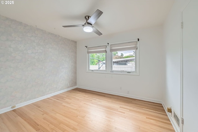 1805 NE Saratoga St, Portland, OR 97211 - spare room featuring light wood-style floors, baseboards, ceiling fan, and wallpapered walls