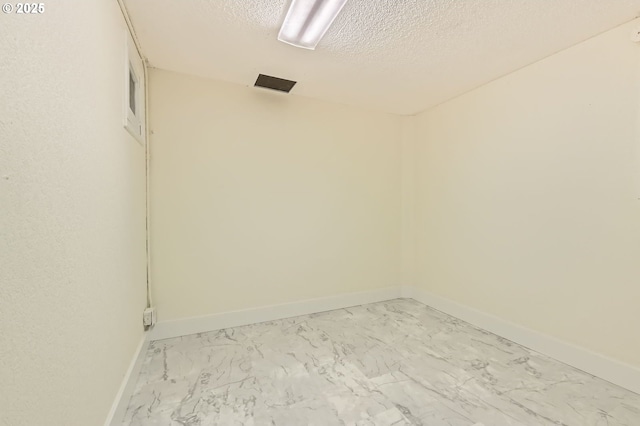 1805 NE Saratoga St, Portland, OR 97211 - spare room with light marble finish floors, a textured ceiling, and baseboards