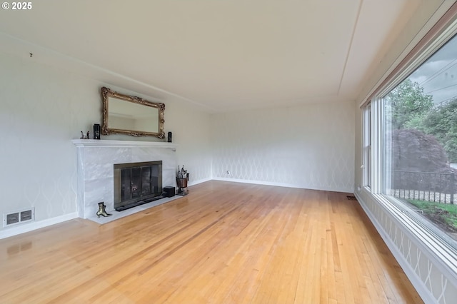 1805 NE Saratoga St, Portland, OR 97211 - unfurnished living room featuring hardwood / wood-style flooring and a fireplace