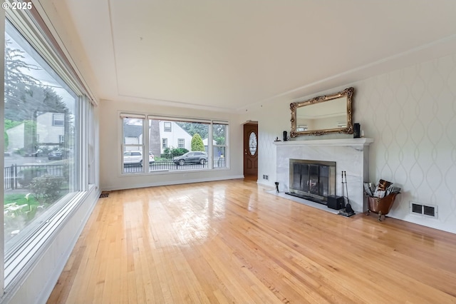1805 NE Saratoga St, Portland, OR 97211 - unfurnished living room featuring wallpapered walls, hardwood / wood-style floors, and a fireplace