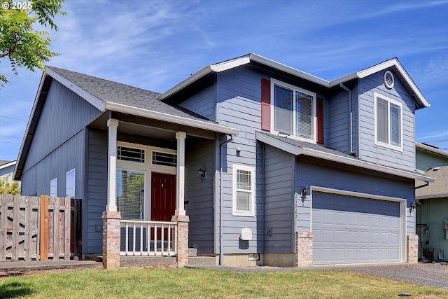 view of front of home with a garage, fence, and asphalt driveway