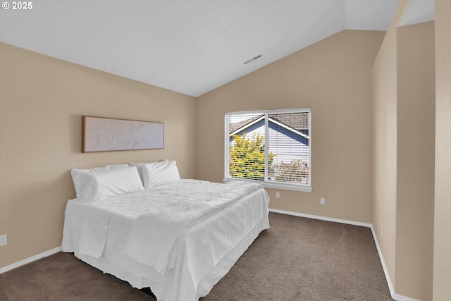bedroom featuring vaulted ceiling, dark colored carpet, and baseboards