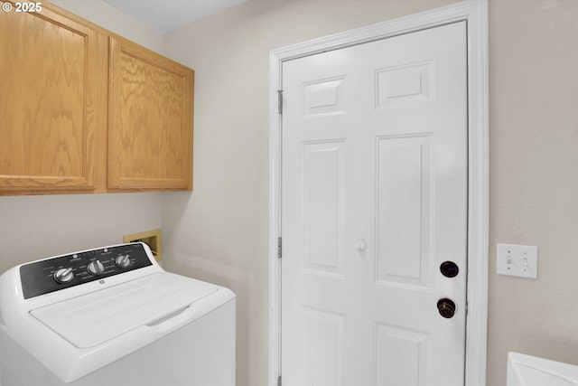 washroom with washer / dryer and cabinet space