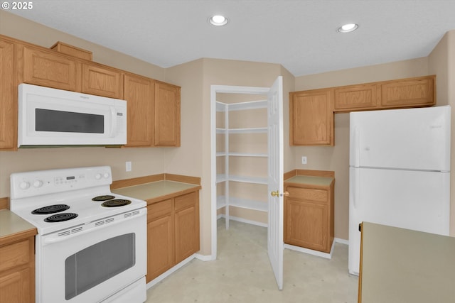 kitchen featuring white appliances, light countertops, light flooring, recessed lighting, and baseboards