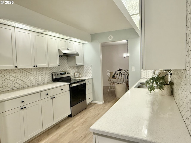 1689 NW Martin Ave, Roseburg, OR 97471 - kitchen with stainless steel electric range, backsplash, under cabinet range hood, and light wood-style floors