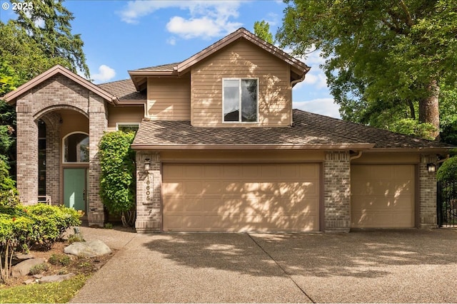 16605 SW Sumac St, Beaverton, OR 97007 - traditional-style house with brick siding, concrete driveway, and roof with shingles