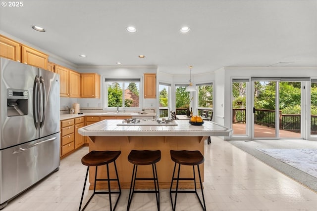 16605 SW Sumac St, Beaverton, OR 97007 - kitchen with stainless steel refrigerator with ice dispenser, tile countertops, ornamental molding, light brown cabinetry, and a center island
