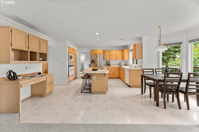 16605 SW Sumac St, Beaverton, OR 97007 - kitchen with white appliances, a kitchen breakfast bar, a kitchen island, light countertops, and ornamental molding