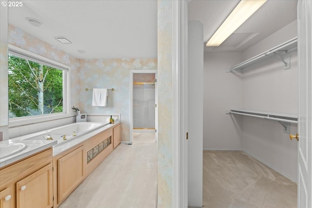 16605 SW Sumac St, Beaverton, OR 97007 - full bathroom with a walk in closet, a bath, a shower stall, baseboards, and a sink