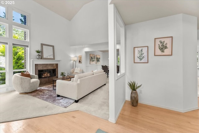 16605 SW Sumac St, Beaverton, OR 97007 - living room featuring wood finished floors, a premium fireplace, baseboards, and high vaulted ceiling