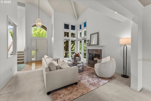 16605 SW Sumac St, Beaverton, OR 97007 - carpeted living room featuring high vaulted ceiling, a fireplace, baseboards, a chandelier, and stairs