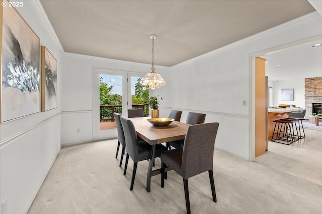 16605 SW Sumac St, Beaverton, OR 97007 - dining space with light colored carpet, a chandelier, crown molding, a fireplace, and baseboards
