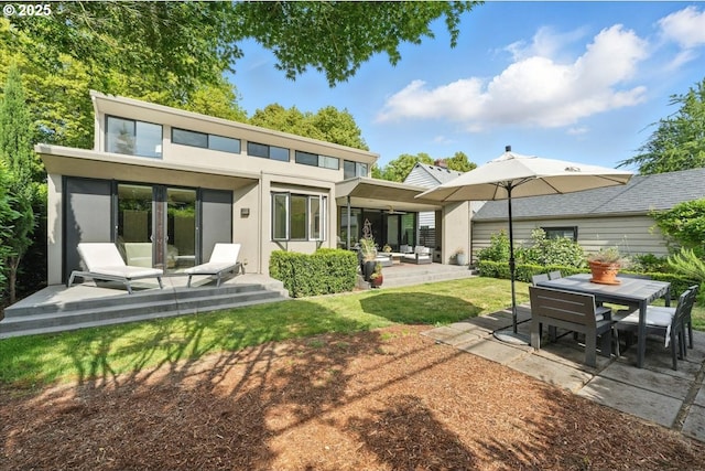 7338 N Chase Ave, Portland, OR 97217 - rear view of property featuring a patio, stucco siding, and outdoor dining space