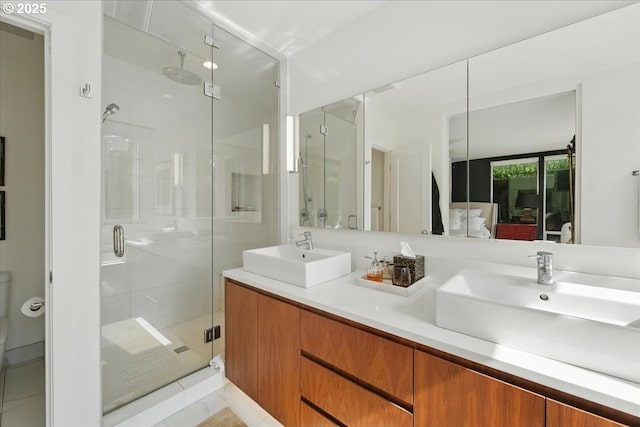 7338 N Chase Ave, Portland, OR 97217 - bathroom with a shower stall, double vanity, and tile patterned floors