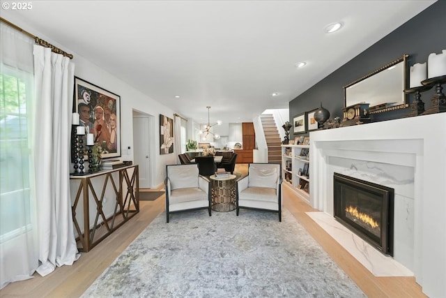 7338 N Chase Ave, Portland, OR 97217 - living room with wood finished floors, a fireplace, a chandelier, and recessed lighting