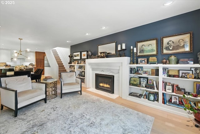 7338 N Chase Ave, Portland, OR 97217 - living room with a fireplace, wood finished floors, stairway, recessed lighting, and a chandelier
